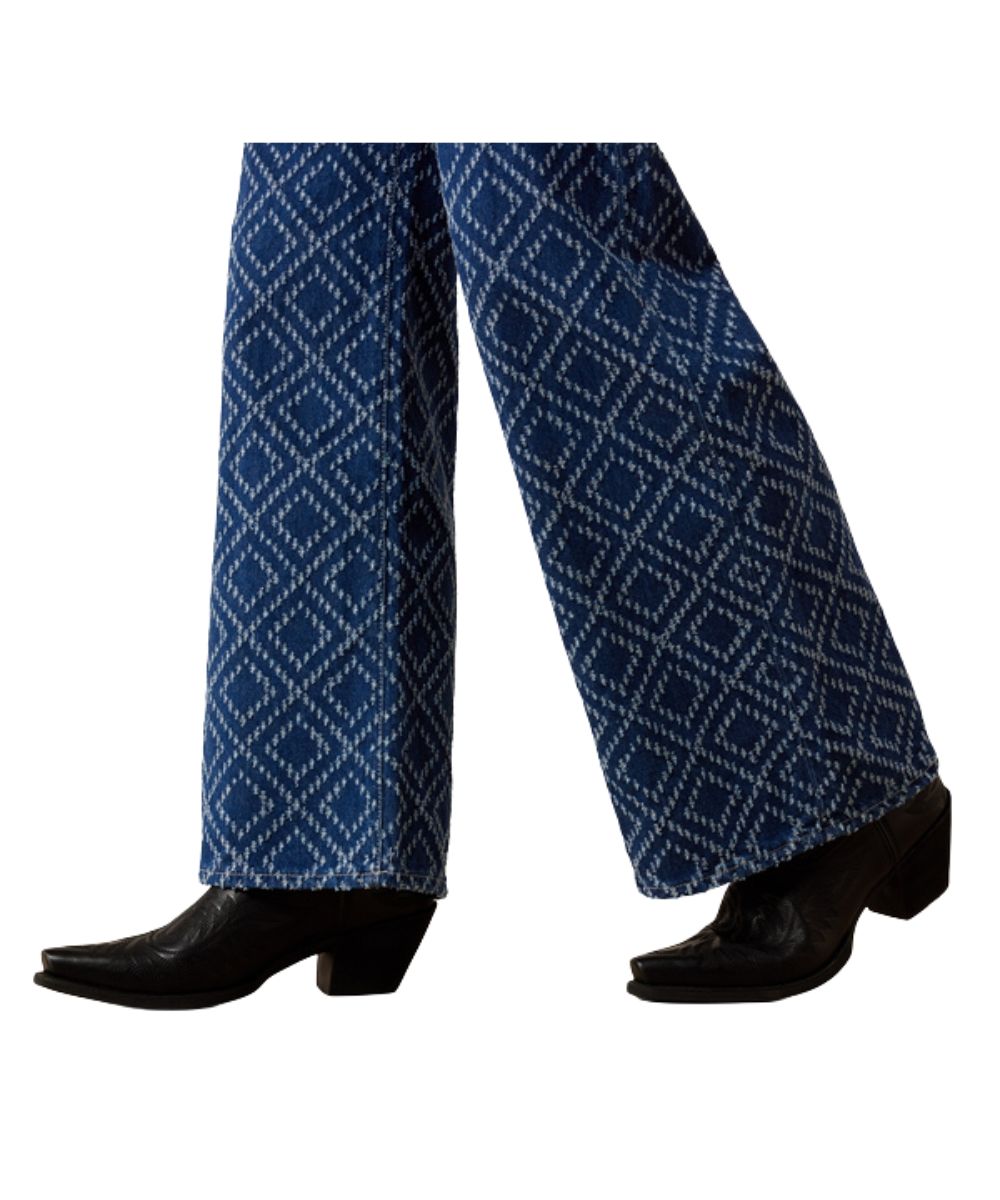 Leg view featuring the wide leg and textured needle-punch diamond pattern on the women's relaxed blue jean