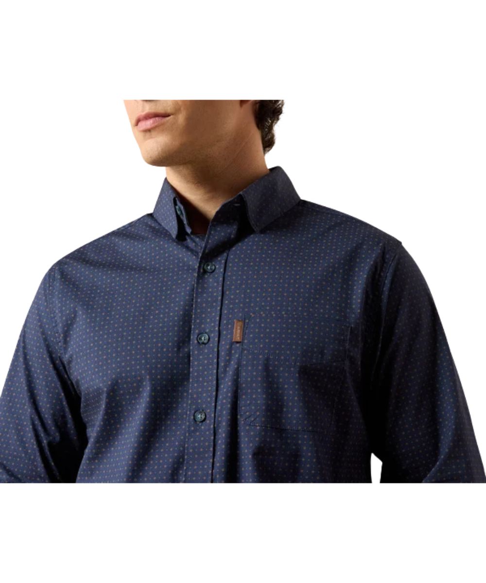 Close-up view of the navy button down shirt featuring the mini geo print, hidden button down collar, and chest pocket with a hidden pen slot