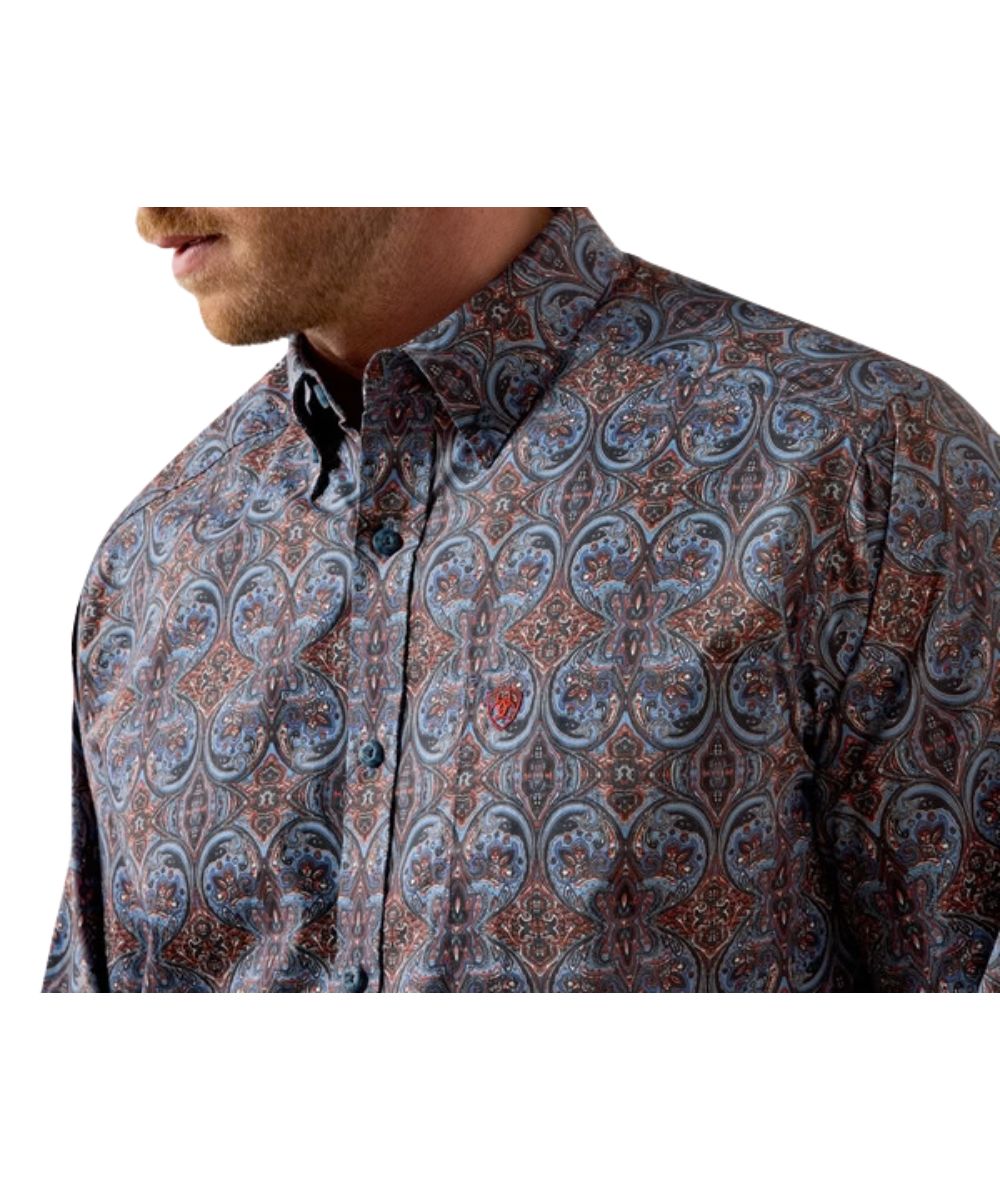 Close-up view of the quiet harbor paisley print, single open chest pocket with hidden pen slot, button down collar, and blue buttons