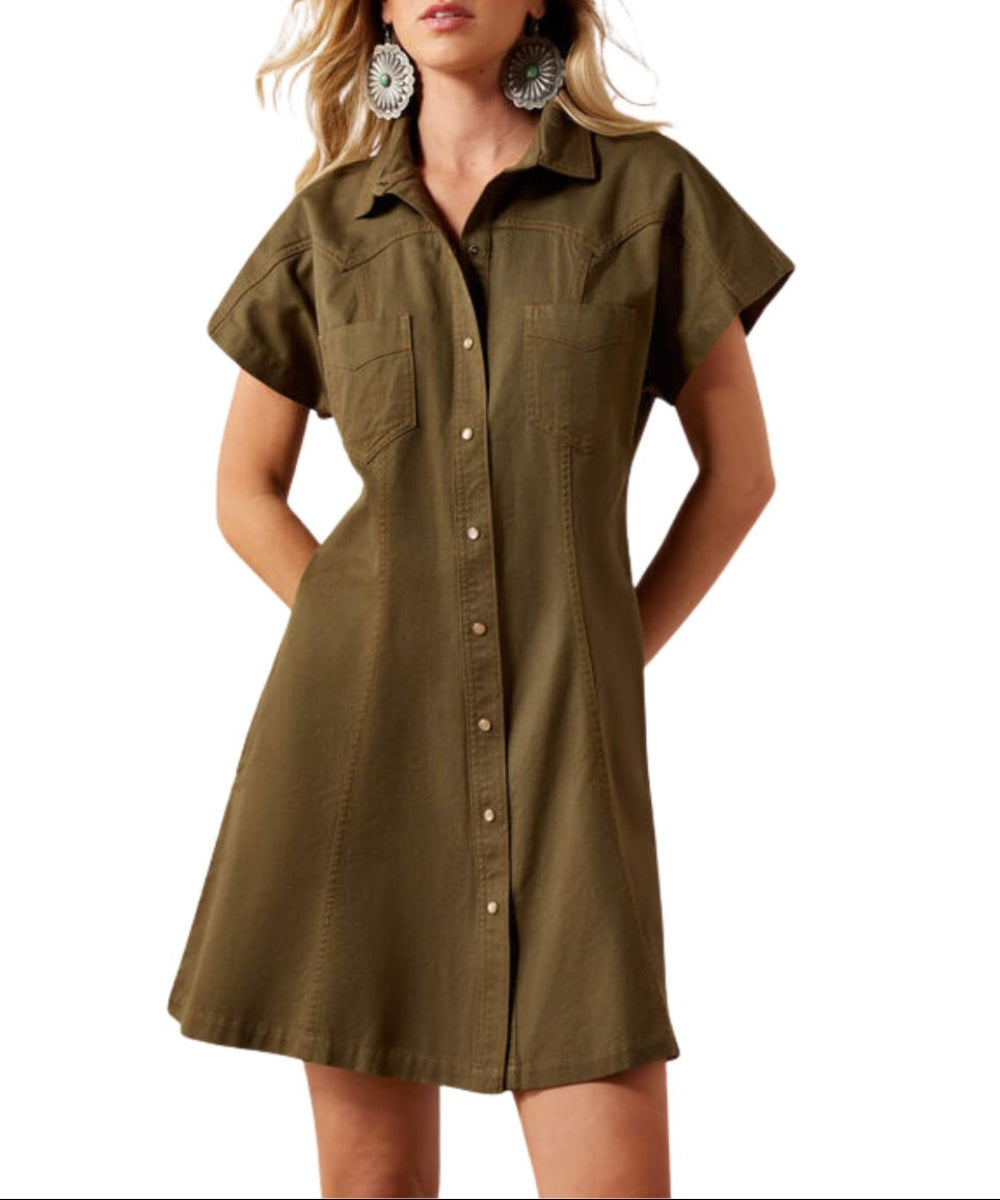 A woman wearing a short-sleeve snap-front shirt dress in ivy green, featuring the western yokes and above knee length