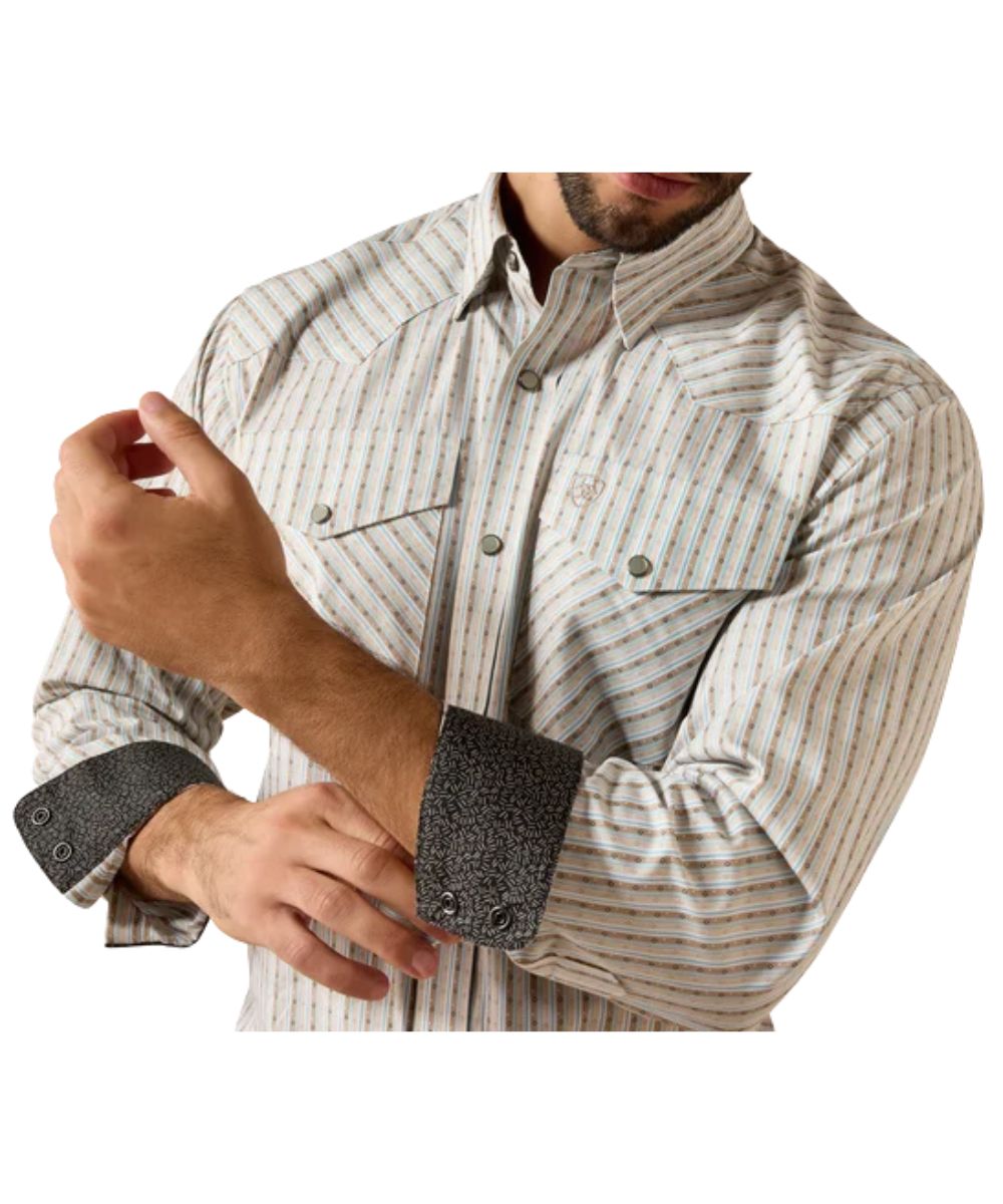 Close-up view of the savannah brown geo printed stripes on the men's cream western pearl snap shirt featuring the wrinkle-free finish, contrast interior trim, snap flap chest pockets with a hidden pen slot, and western yokes