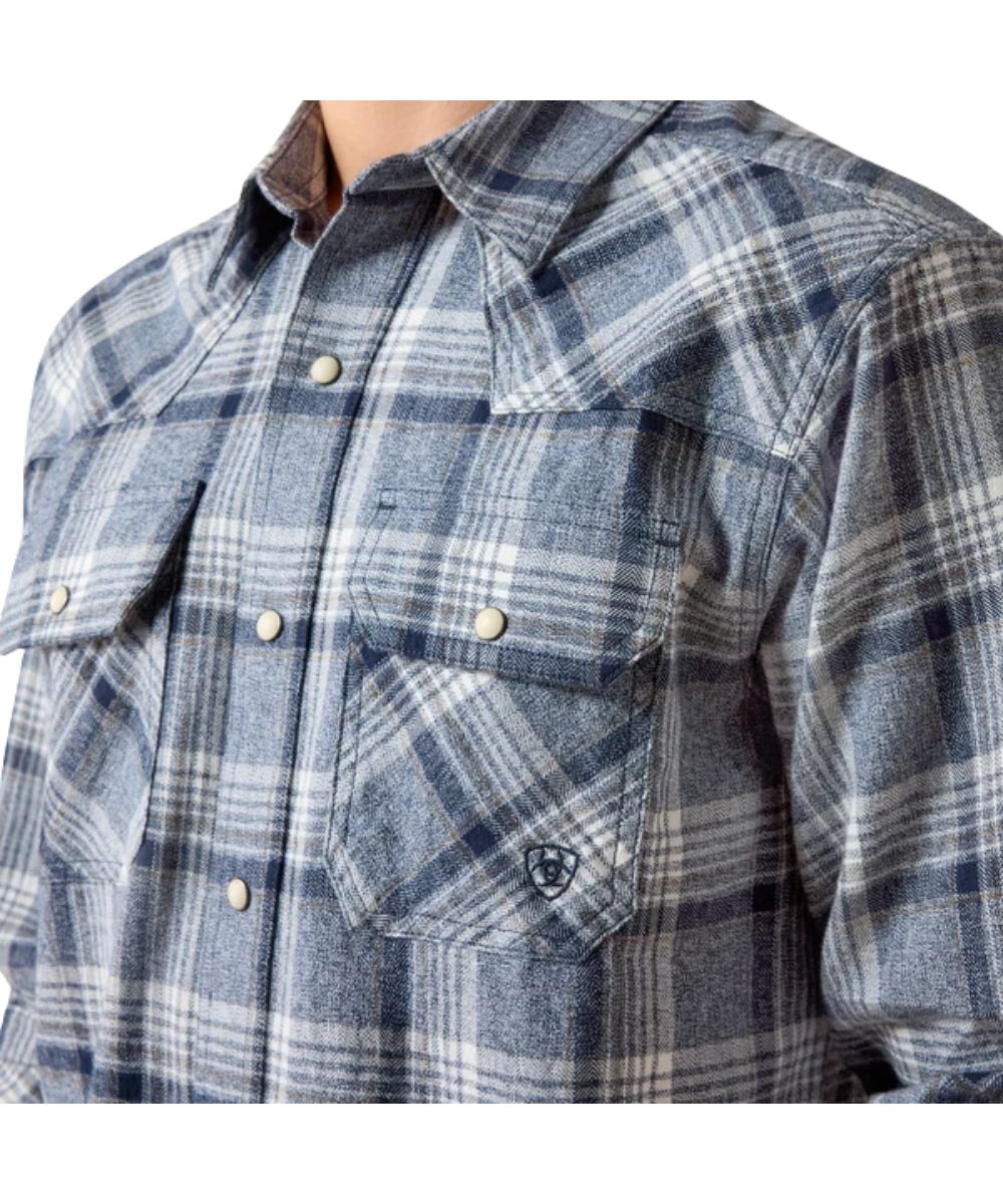 Close-up view of the blue/grey plaid print featuring the single point front yokes and snap flap chest pockets