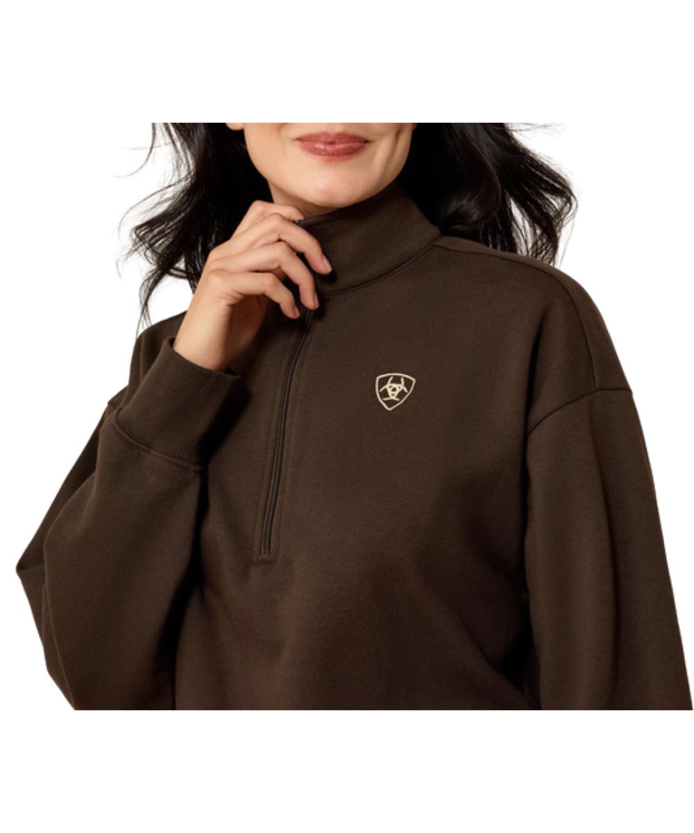 Close-up view of the women's brown sweatshirt featuring the contrast logo embroidery at the left chest