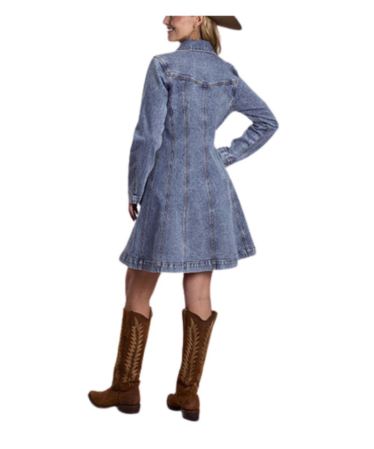 A woman shown from the back wearing a light blue denim long-sleeve dress with a high collar and brown cowboy boots against a plain white background.