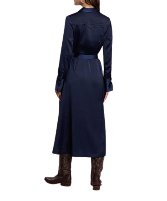 Back view of the women's navy satin dress featuring the midi length and single point western yokes with chocolate brown piping