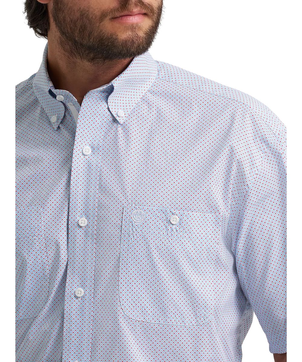 Close-up view of the blue shirt in red dot print featuring button-through chest pockets, a button-down collar, and button-down placket.