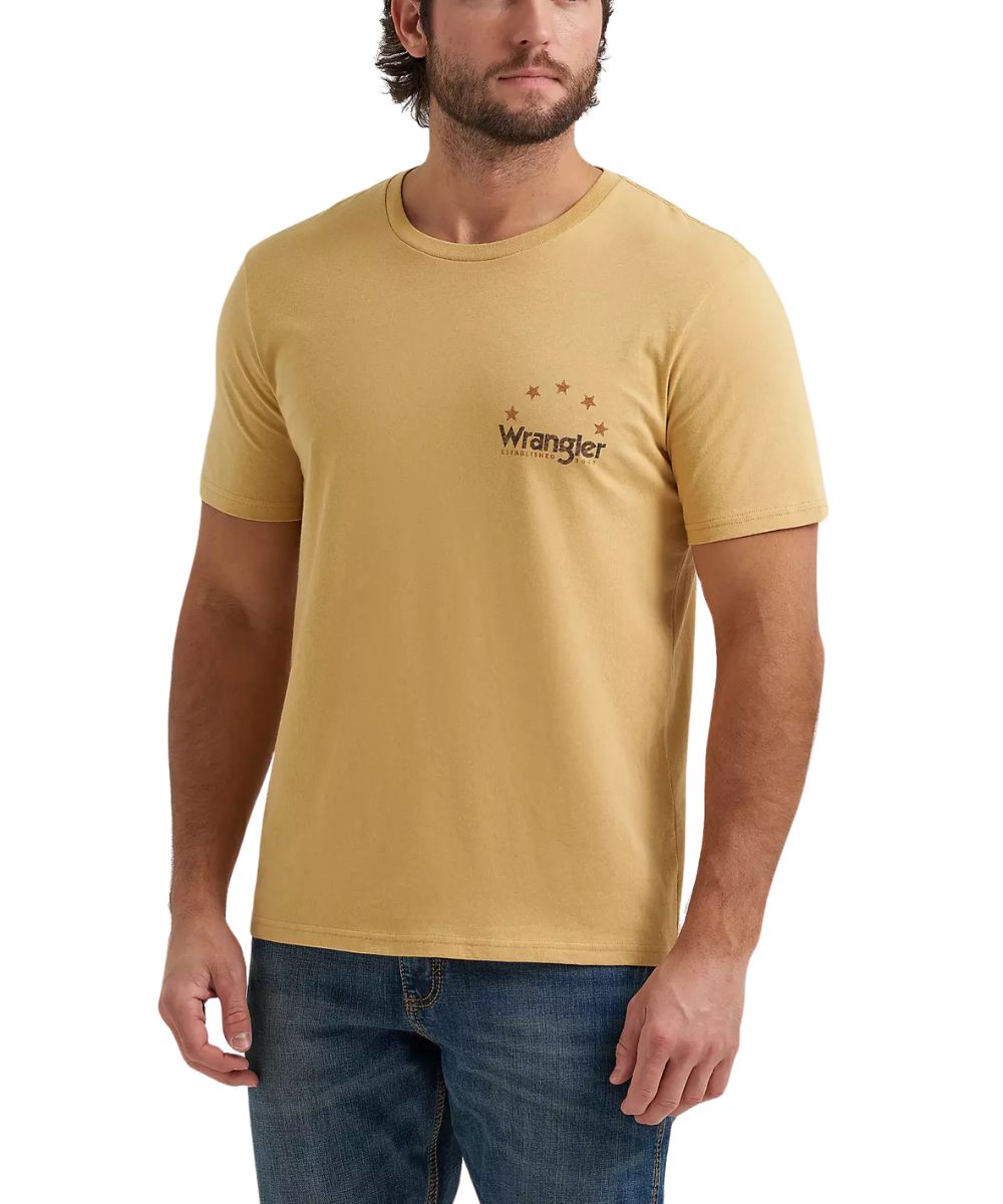 model wearing short sleeve tshirt with wrangler logo on left chest while also wearing jeans on a white background