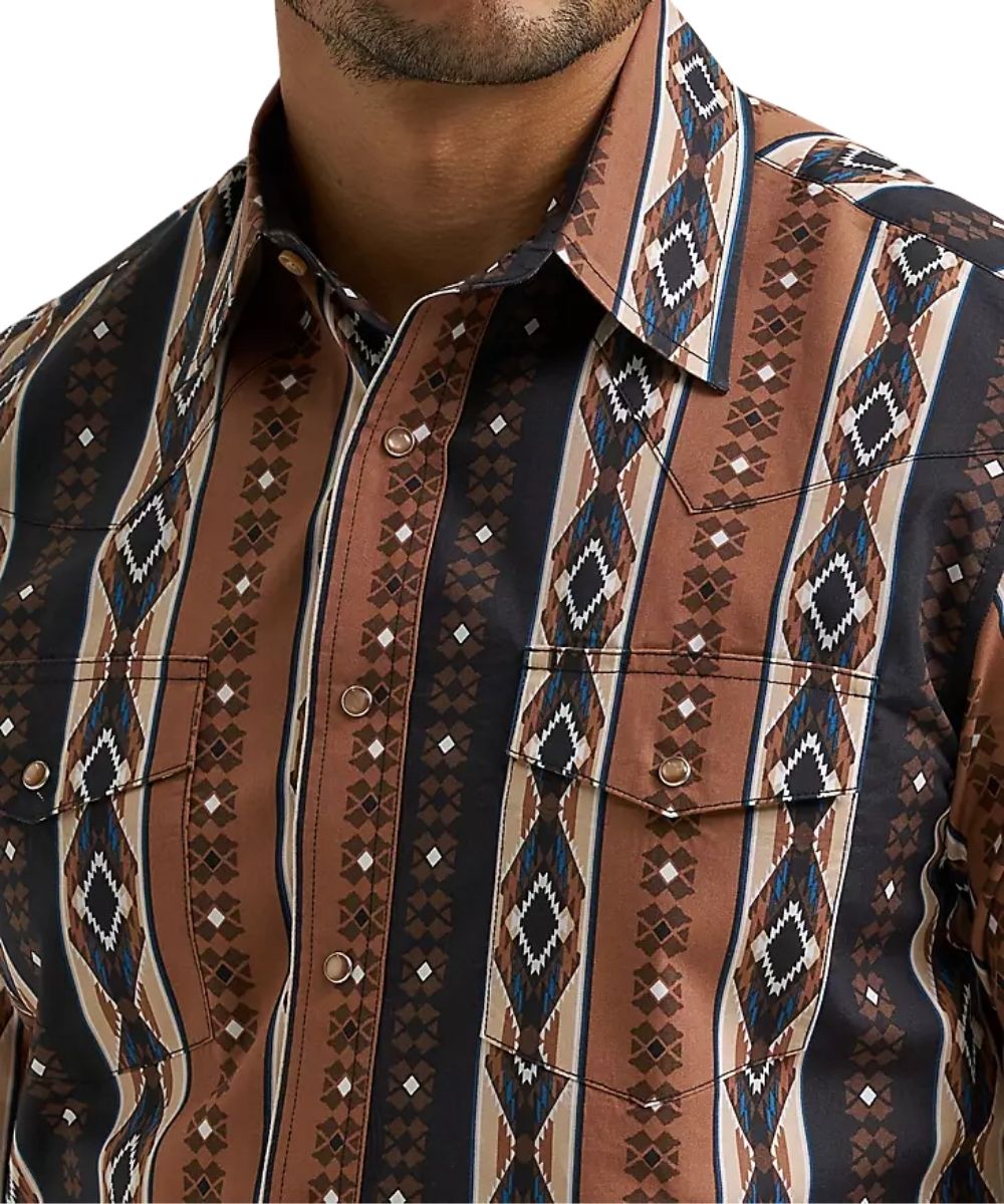 A close-up of a men's western-style button-down shirt featuring a brown, black, and beige geometric tribal pattern, worn by a model.