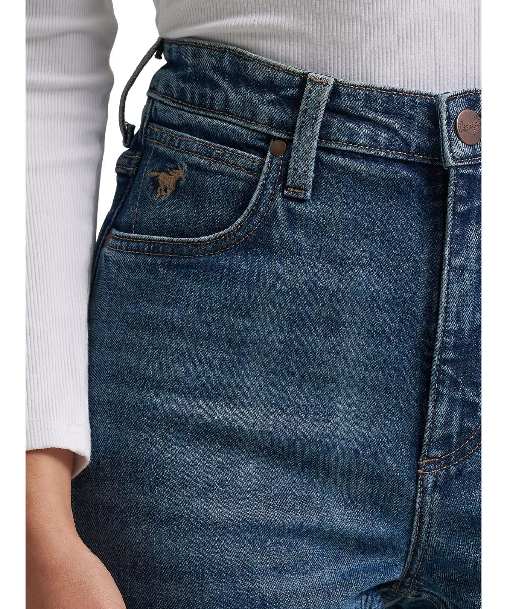 Close-up view of the front pocket with the ultimate riding jean logo embroidered at the coin pocket