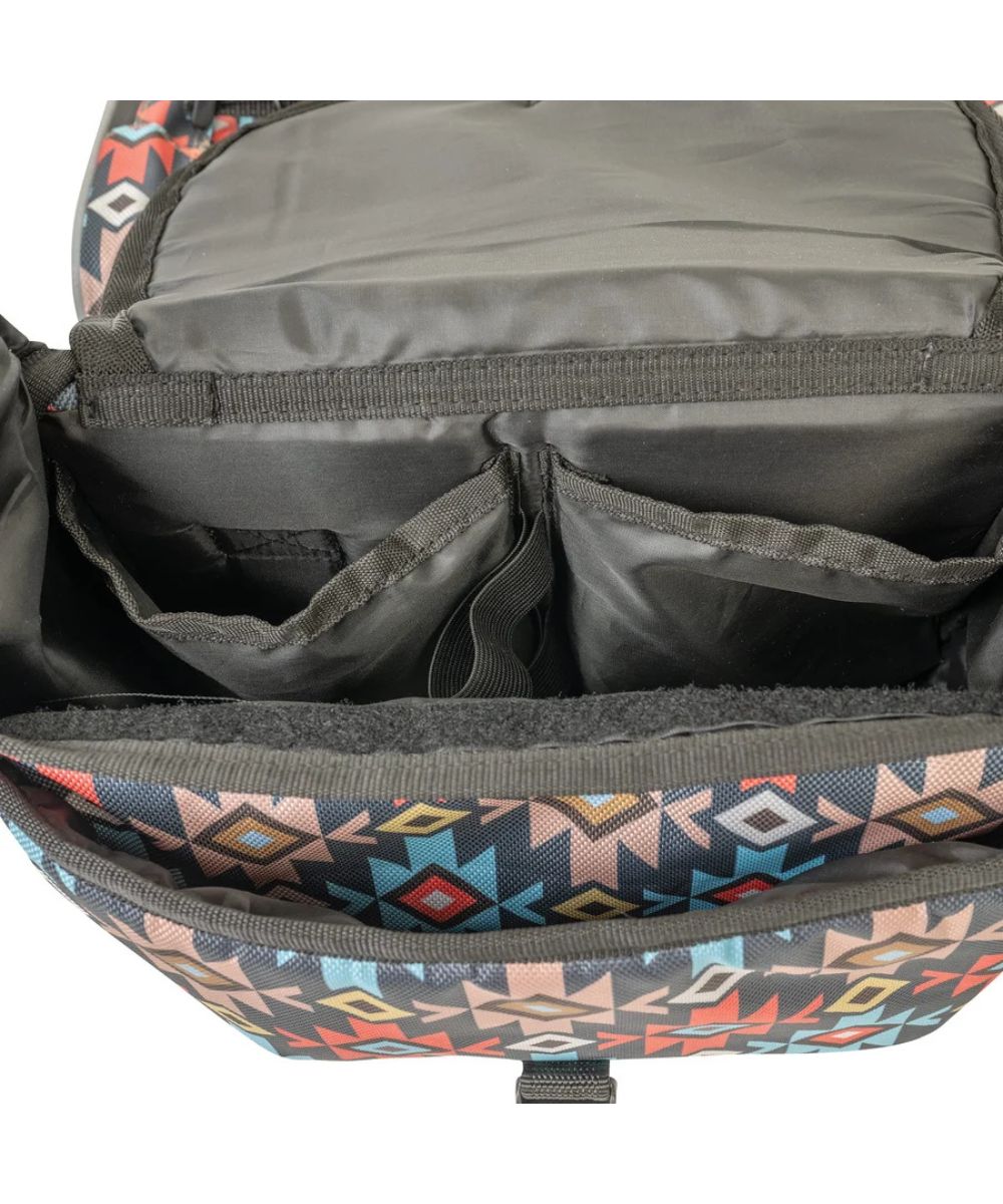 Close-up of the interior of a bag, showing dark gray fabric compartments, elastic bands, and a patterned exterior with geometric shapes in pink, blue, orange, and black.