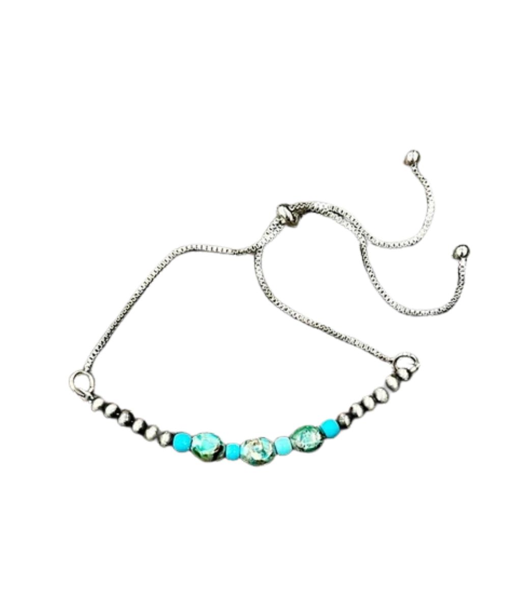 Flat view of the women's Isac Trading Adjustable Chain Bracelet featuring the oval gemstones and navajo beads