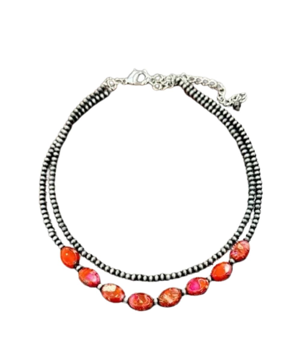 Flat view of the women's 15" necklace with a 5" extender featuring the coral color gemstone beads and tiny navajo style beads