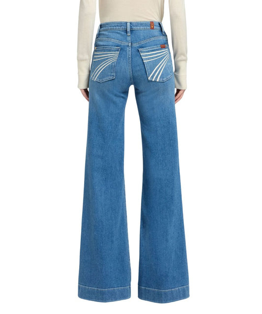 Back view of the women's high rise trouser jean featuring the mid wash and trouser hem