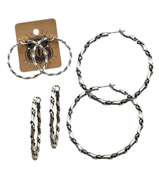 Multiple views of the women's silver hoop earrings measuring approximately 2" in length