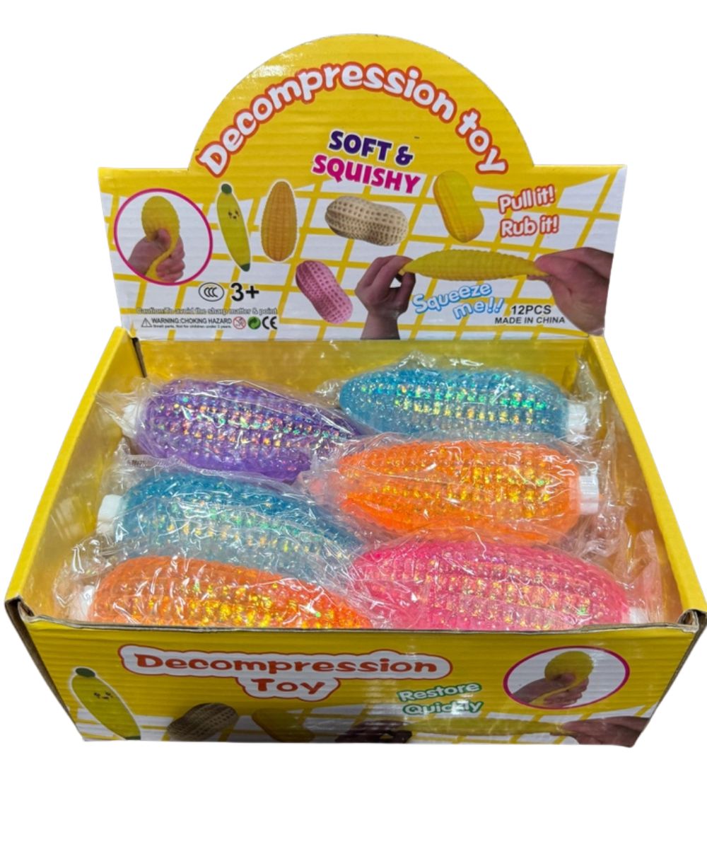 A retail display box of colorful decompression toys. The yellow and white cardboard box contains six small, squishy, plastic corn-shaped toys in purple, blue, orange, and pink, each wrapped in clear plastic.