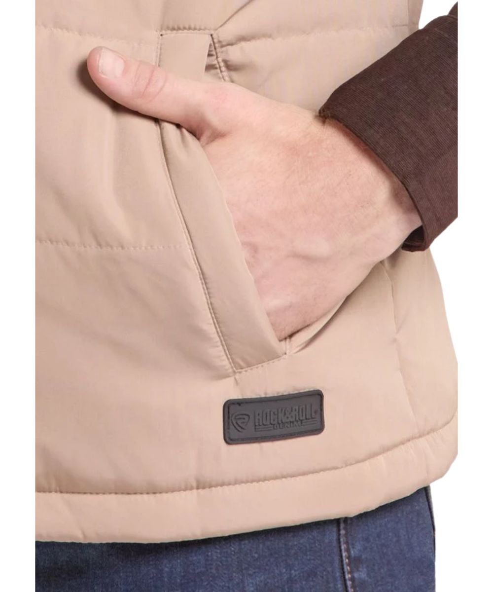 Close-up view of the tan polyester vest featuring the hand pockets