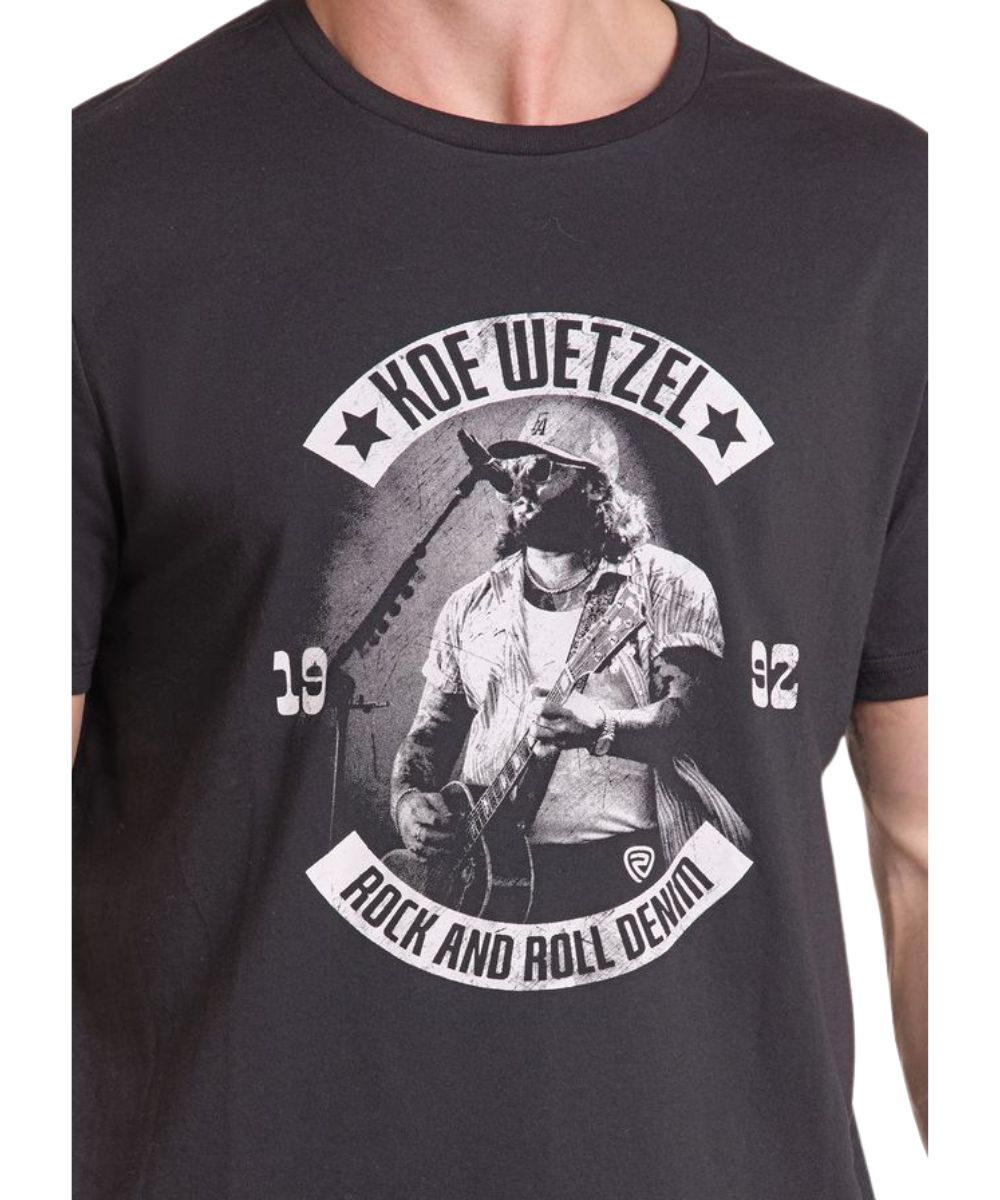 Close-up view of the screen-printed Koe Wetzel graphic on the front of the black tee featuring Koe playing the guitar and singing into a microphone