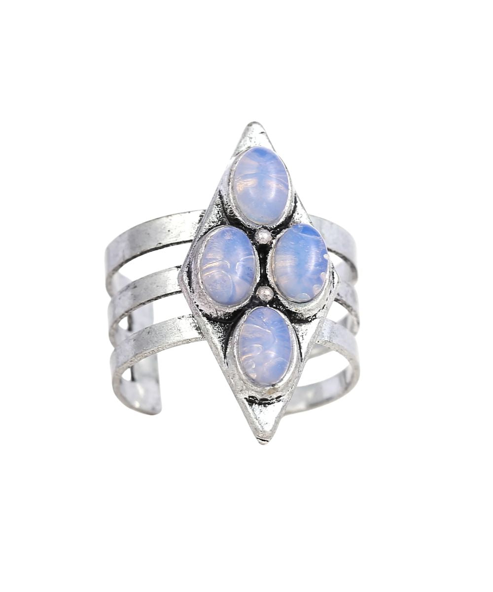 A silver-toned wrap ring featuring four oval light blue opal-like stones arranged in a diamond pattern on the front, set against a plain white background.
