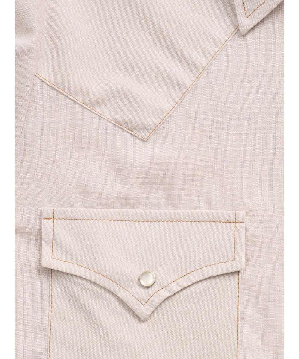 Close-up fabric view of the women's shirt featuring single point snap flap chest pockets, ecru snaps, and single point western yokes