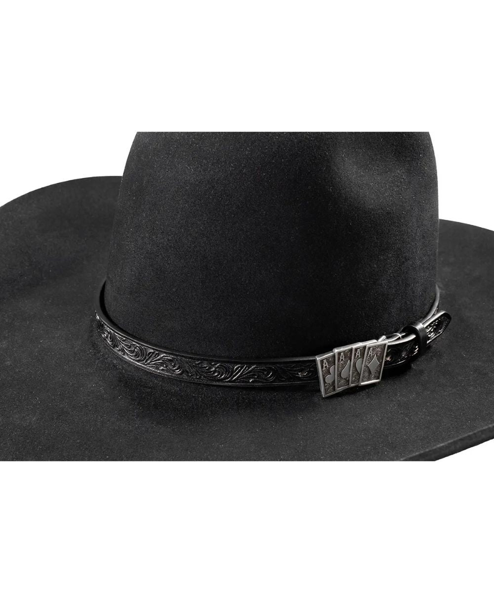 A close-up of a black wide-brim hat with a black embossed leather band and a silver-toned metal buckle.