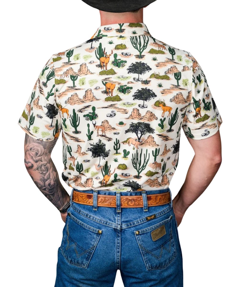 Back view of the men's white short sleeve pearl snap polo shirt featuring the single point back yoke, brown geometric desert wilderness print, and 4-way stretch fabric