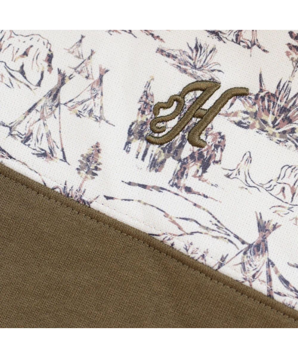 Close-up view of the logo embroidery at the left chest