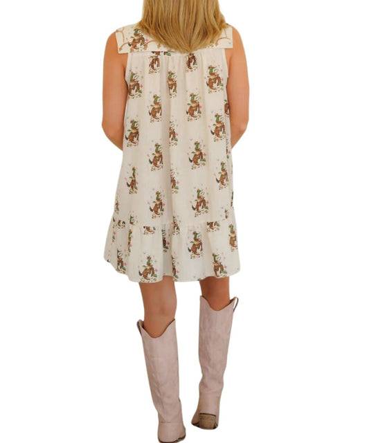 Back view of the women's cowboy embroidery babydoll dress featuring the drop-waist tiered ruffle at hem and mini length