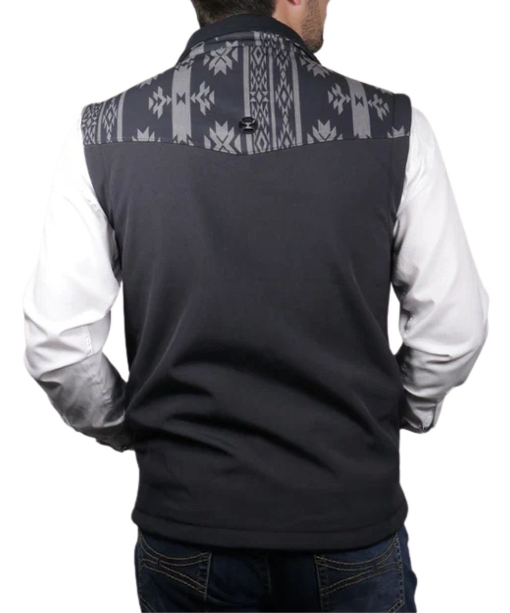 Back view of the men's black softshell vest featuring the aztec printed yokes and all weather protection with wind protection and water resistance
