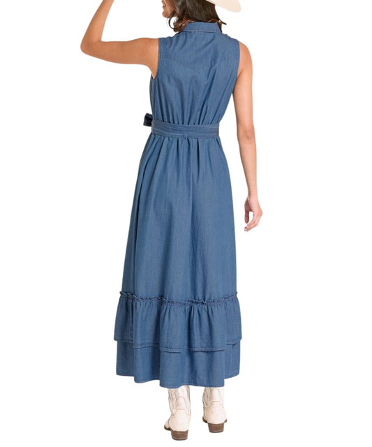 Back view of the midi denim dress featuring a western yoke, elastic waist, self-belt, and tiered ruffle skirt.