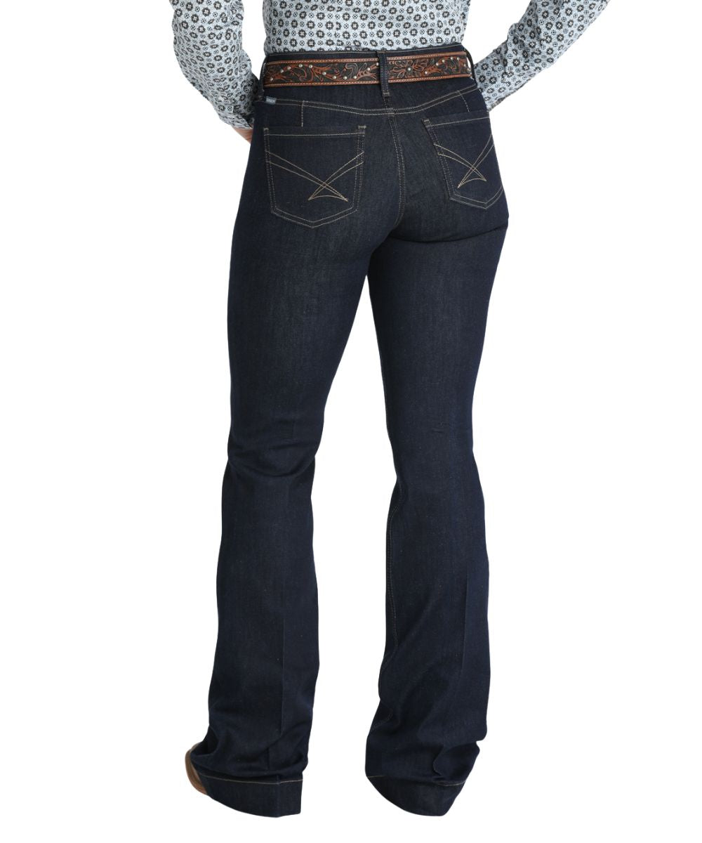 Back view of the women's indigo/rinse trouser jean featuring the moderate rise, five pocket styling, slim flare leg with a trouser hem, and the iconic tan stitched back pocket design