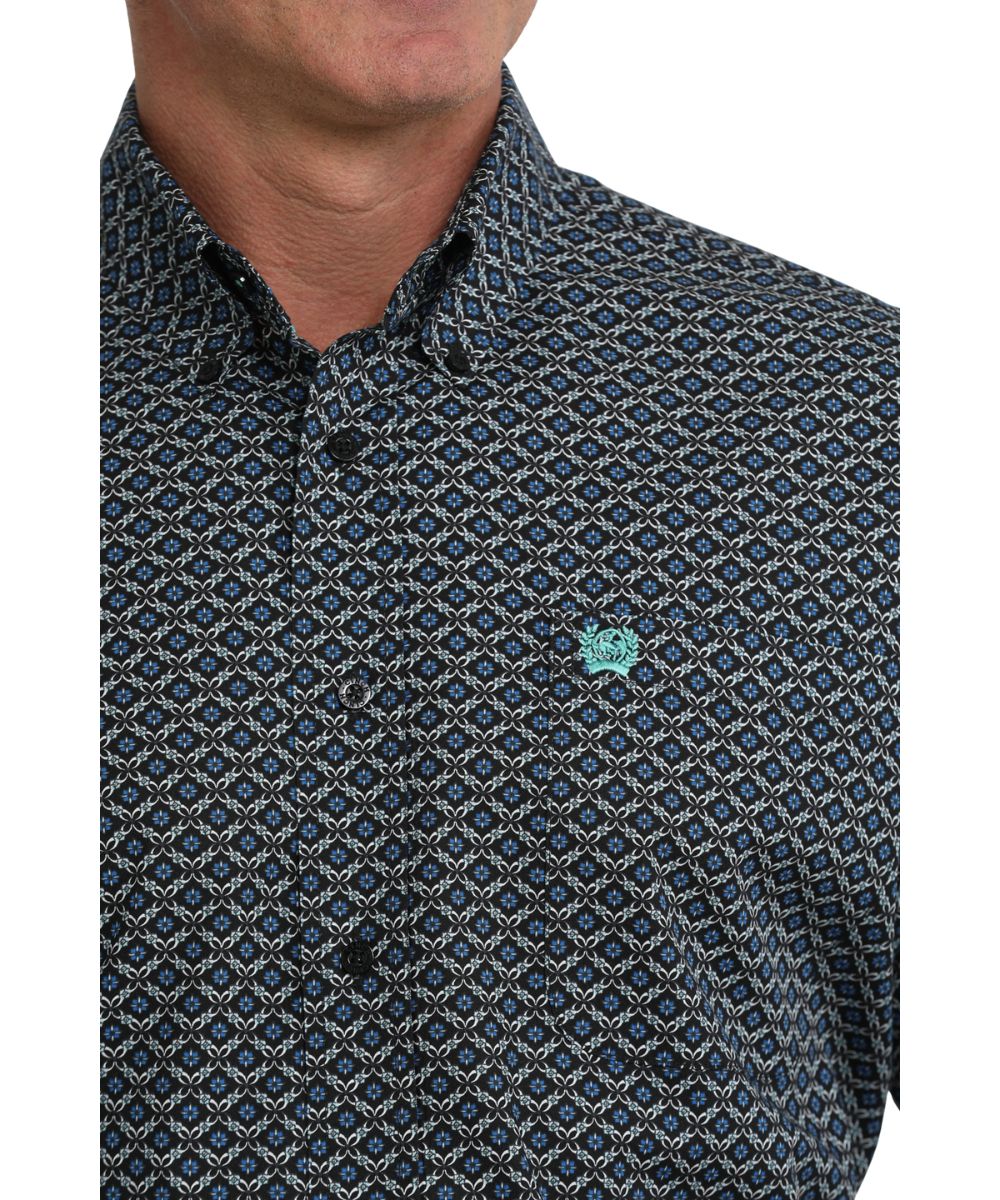 Close-up view of the blue geometric print on the black long sleeve button down shirt