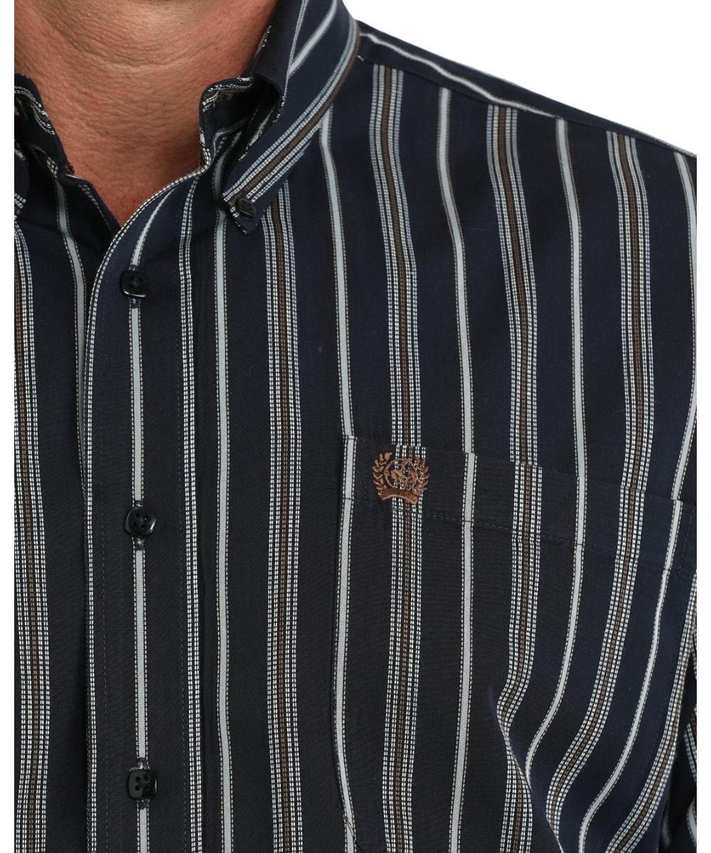 Close-up view of the vertical striped print, navy square buttons, and the single open chest pocket with logo embroidery