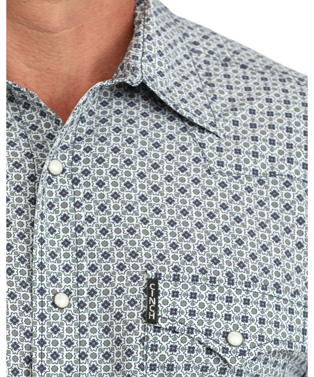 Close-up view of the blue & grey geometric print, white marble snaps, and spread collar