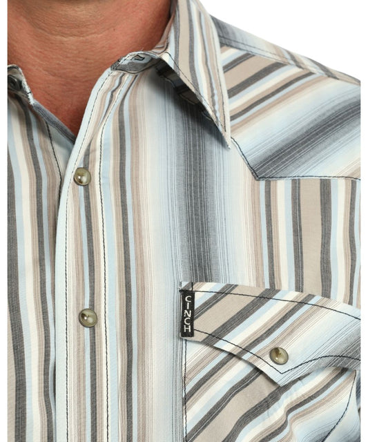 Close-up view of the multicolor striped print, western yokes, brown marble snaps, and the snap flap chest pockets with a logo label