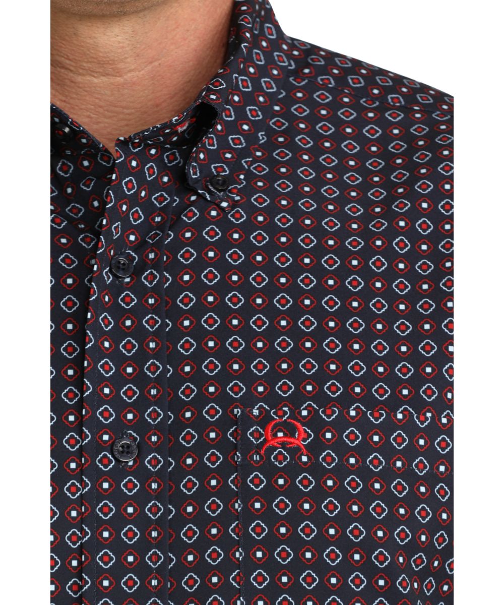 Close-up view of the geometric print, button down collar, and chest pocket