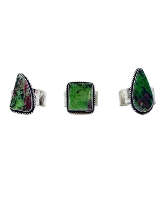 Natural stone may vary in size, color, or shape. This photo displays the varying shapes of the ruby zoisite stone. This ring features an adjustable band
