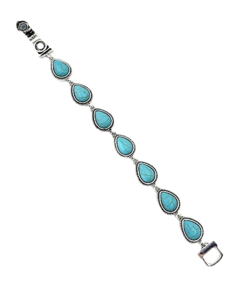 Women's silver tone bracelet featuring the teardrop shaped charms filled with turquoise stones and a magnetic closure