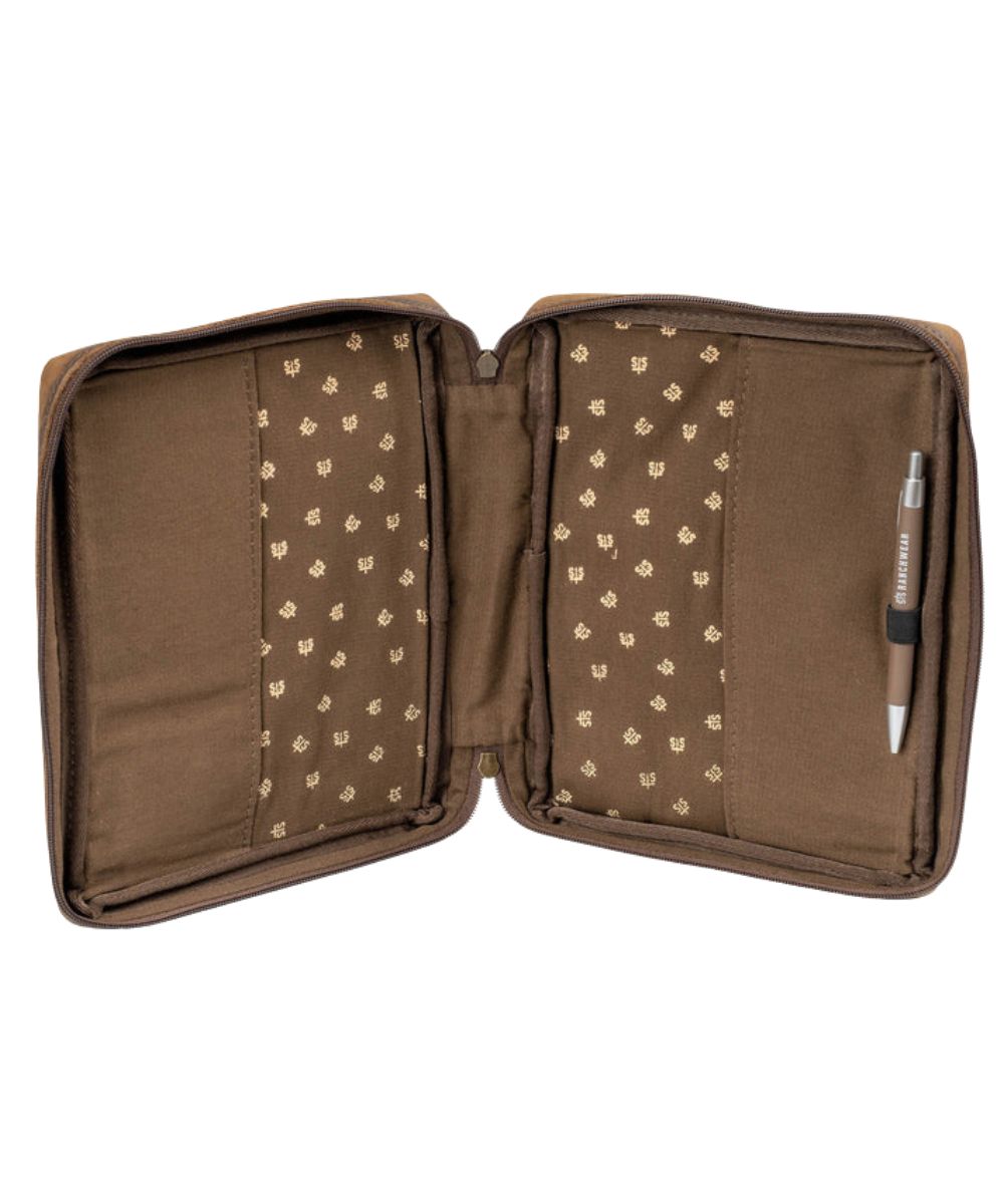 Interior view of the brown leather bible cover featuring the sleeves that hold your bible in place and an interior pen loop