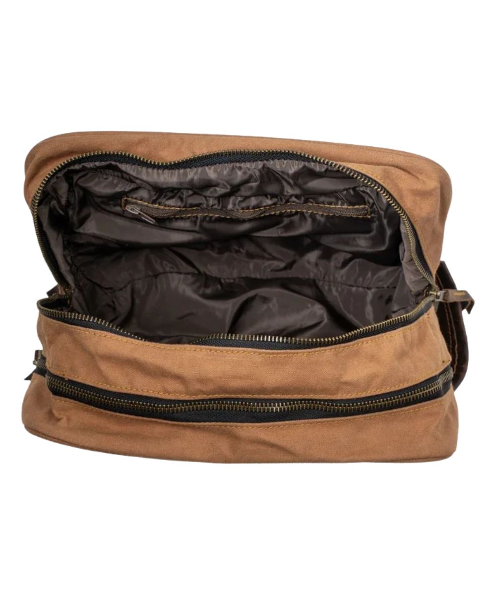 Interior view of the men's tan shave kit featuring the 2 zip closure compartments, 1 interior zip pocket, and a wipeable interior