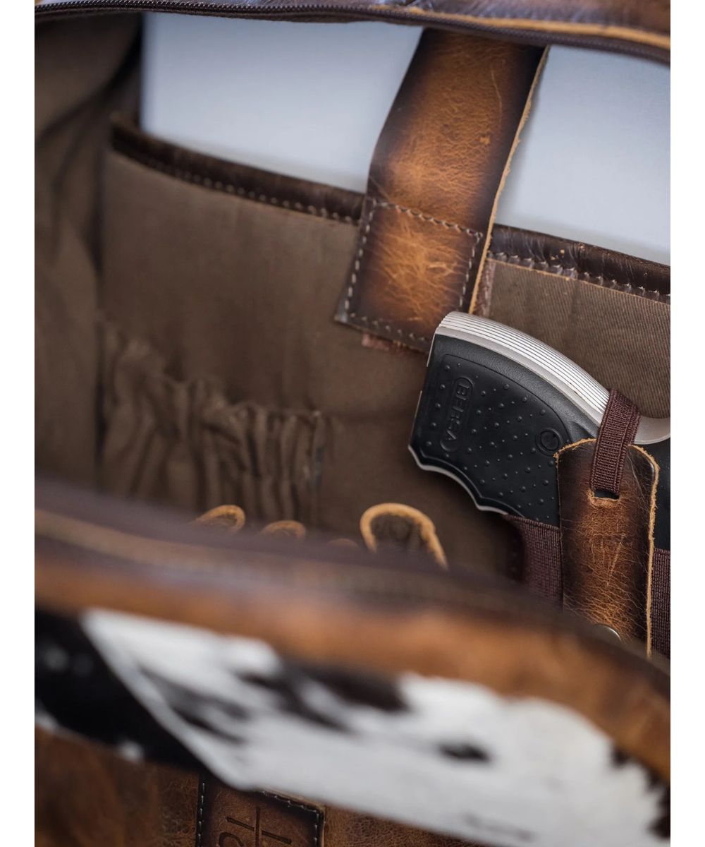 Close-up interior view of the concealed carry pocket and velcro laptop compartment