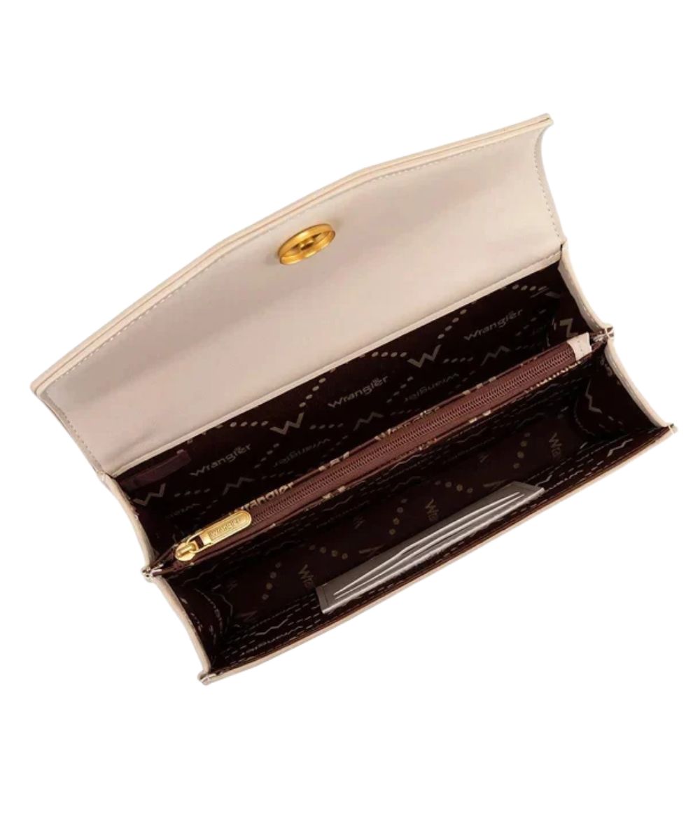 Interior view of the women's tan purse featuring the magnetic flap closure, 2 card slots inside, and a single compartment divided by a medium zippered pocket