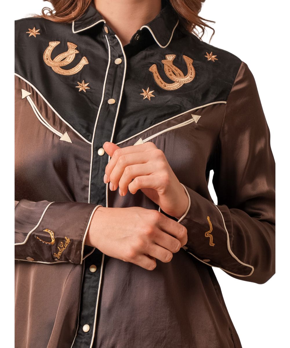 Close-up view of the intricate details on the women's retro-inspired Kimes shirt featuring the white pearl snaps, delicate embroidery, and faux smile chest pockets