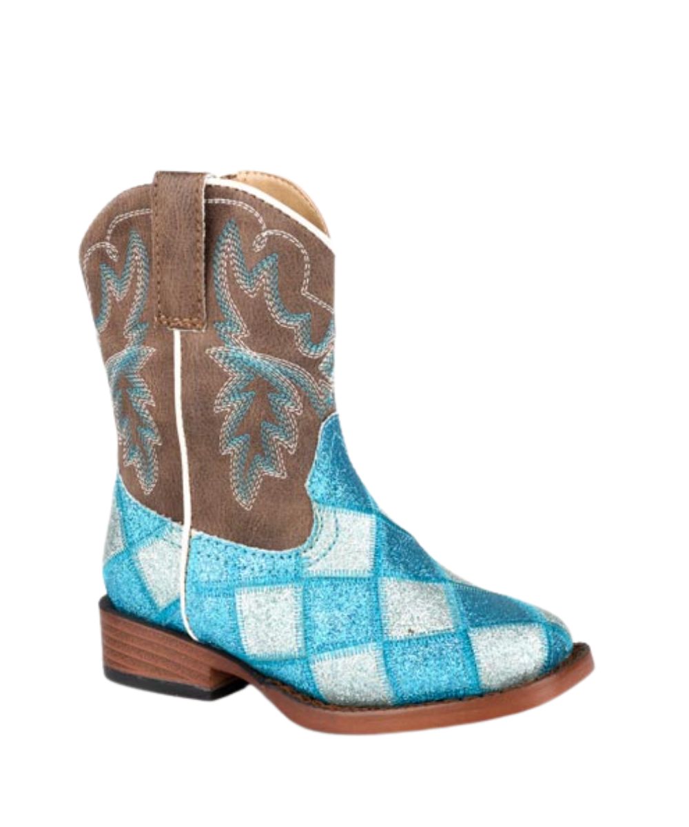 A western-style cowboy boot with a brown shaft featuring turquoise embroidered stitching, and a glittery blue and light blue patchwork patterned foot, shown against a plain white background.