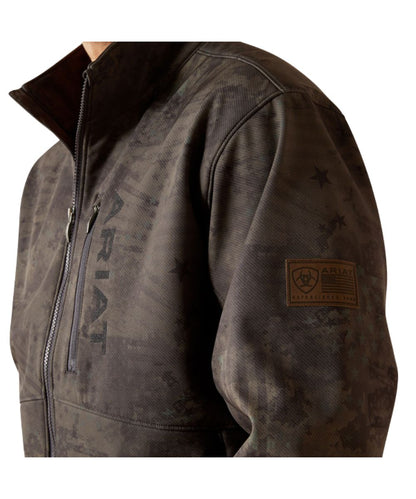 Close-up view of the subtle americana camo print on the men's phantom jacket featuring the leather logo patch on the sleeve, and logo embroidery