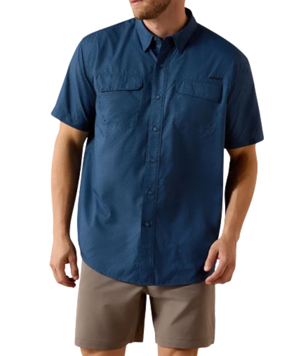 Front view of the men's dark denim navy Ariat VentTEK short sleeve button down shirt featuring the hidden button down collar, chest pockets with velcro closure, geometric print, and the moisture wicking and odor control technology