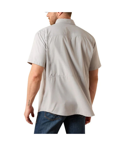 A man shown from the back wearing a light gray short-sleeve button-up shirt and blue jeans against a plain white background.