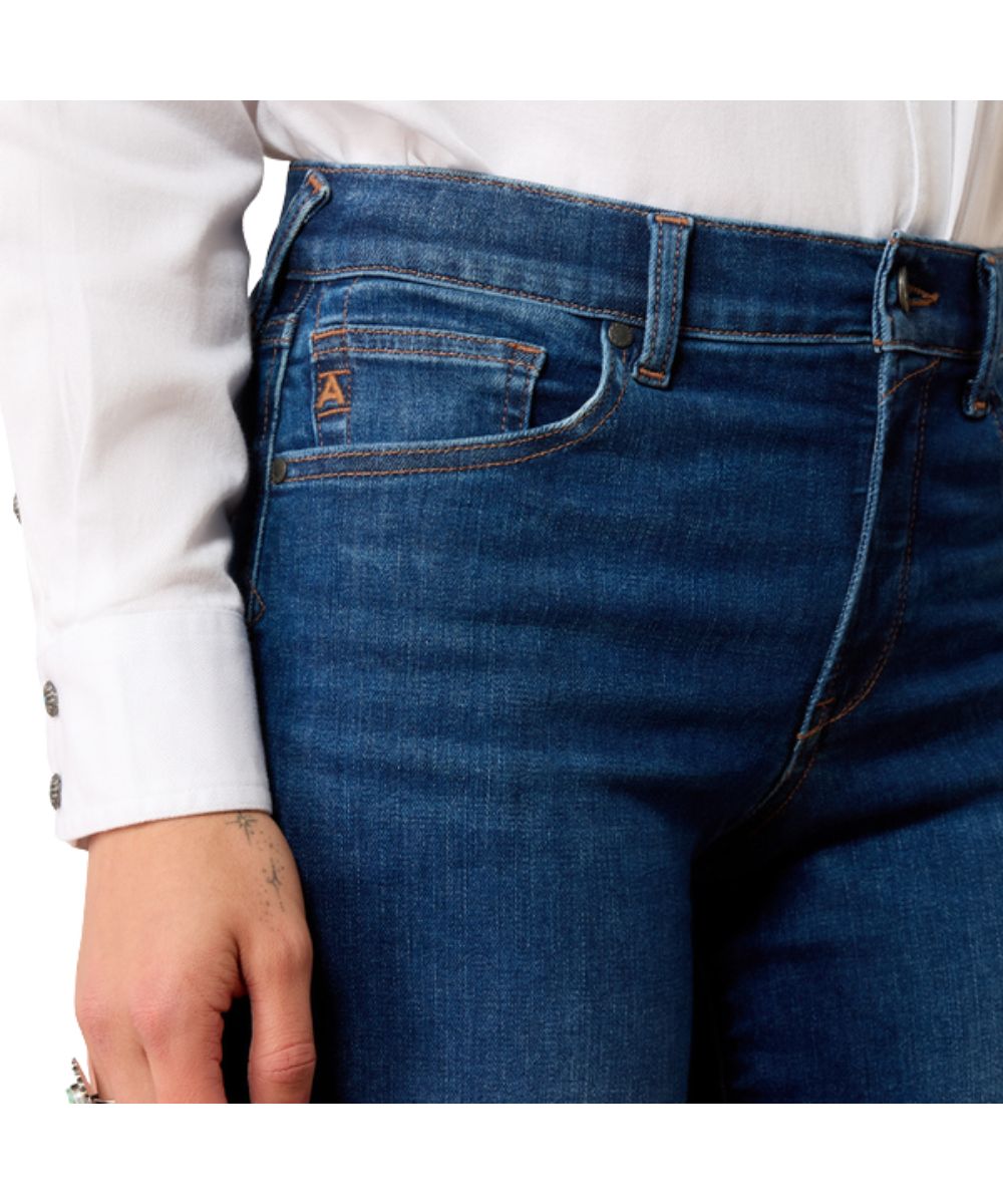 Close-up view of the front pocket featuring the high rise and dark wash