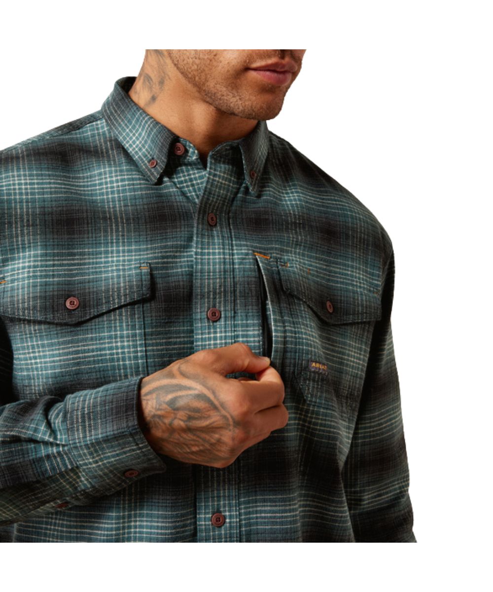 Close-up view of the button down collar, button closure, button flap chest pockets, hidden pen slot, and zipper chest pocket