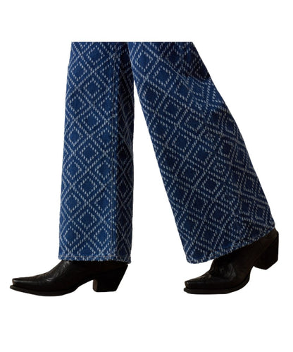 Leg view featuring the wide leg and textured needle-punch diamond pattern on the women's relaxed blue jean