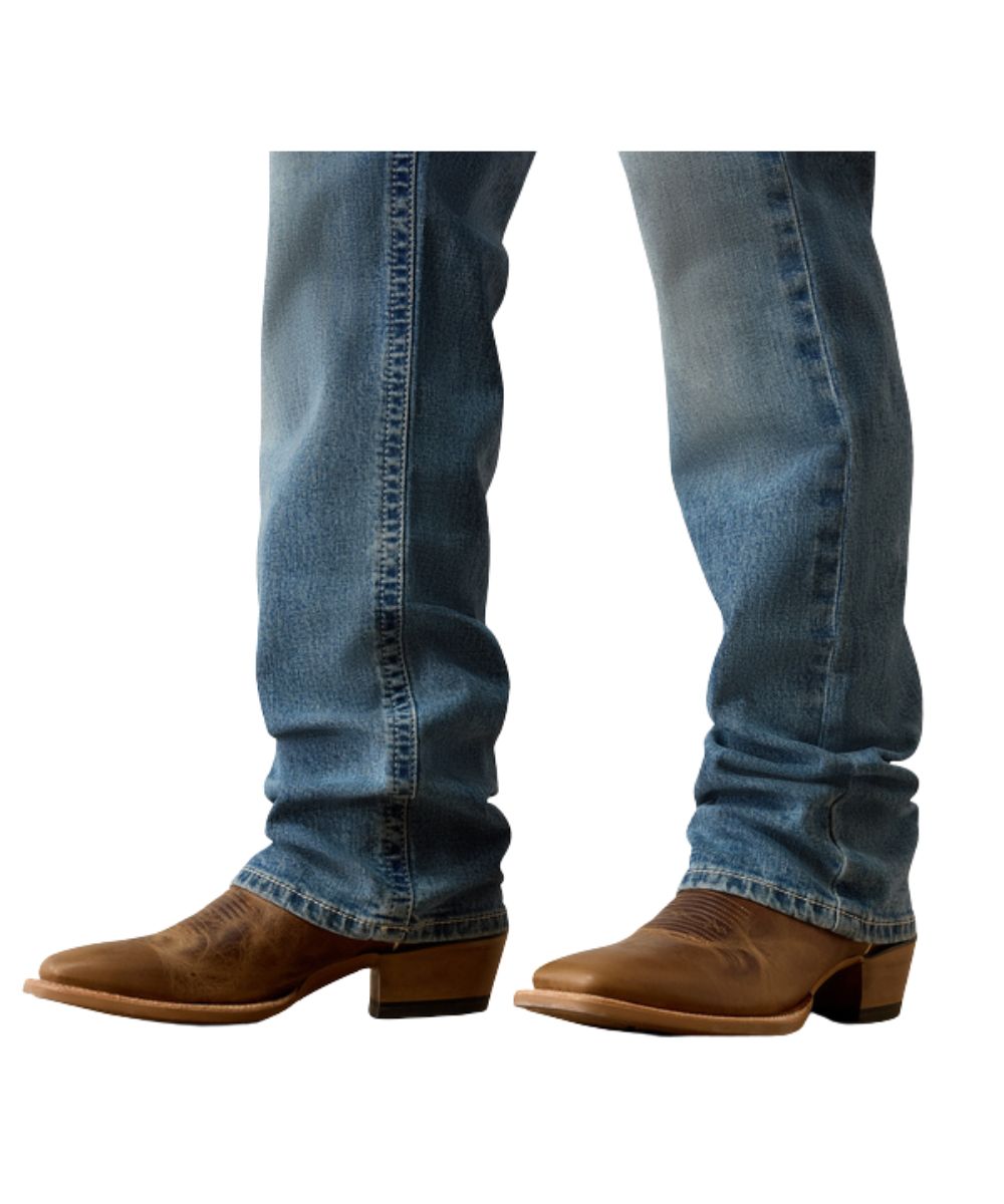 Close-up view of the straight leg for a slimmer fit over boots in the men's m5 straight jean logan medium wash